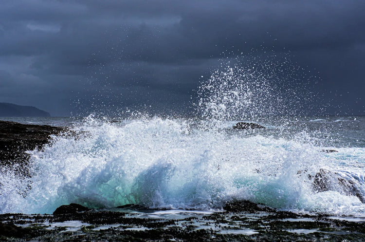 A wave breaking against the shoreline, photographed by Judy Rissling